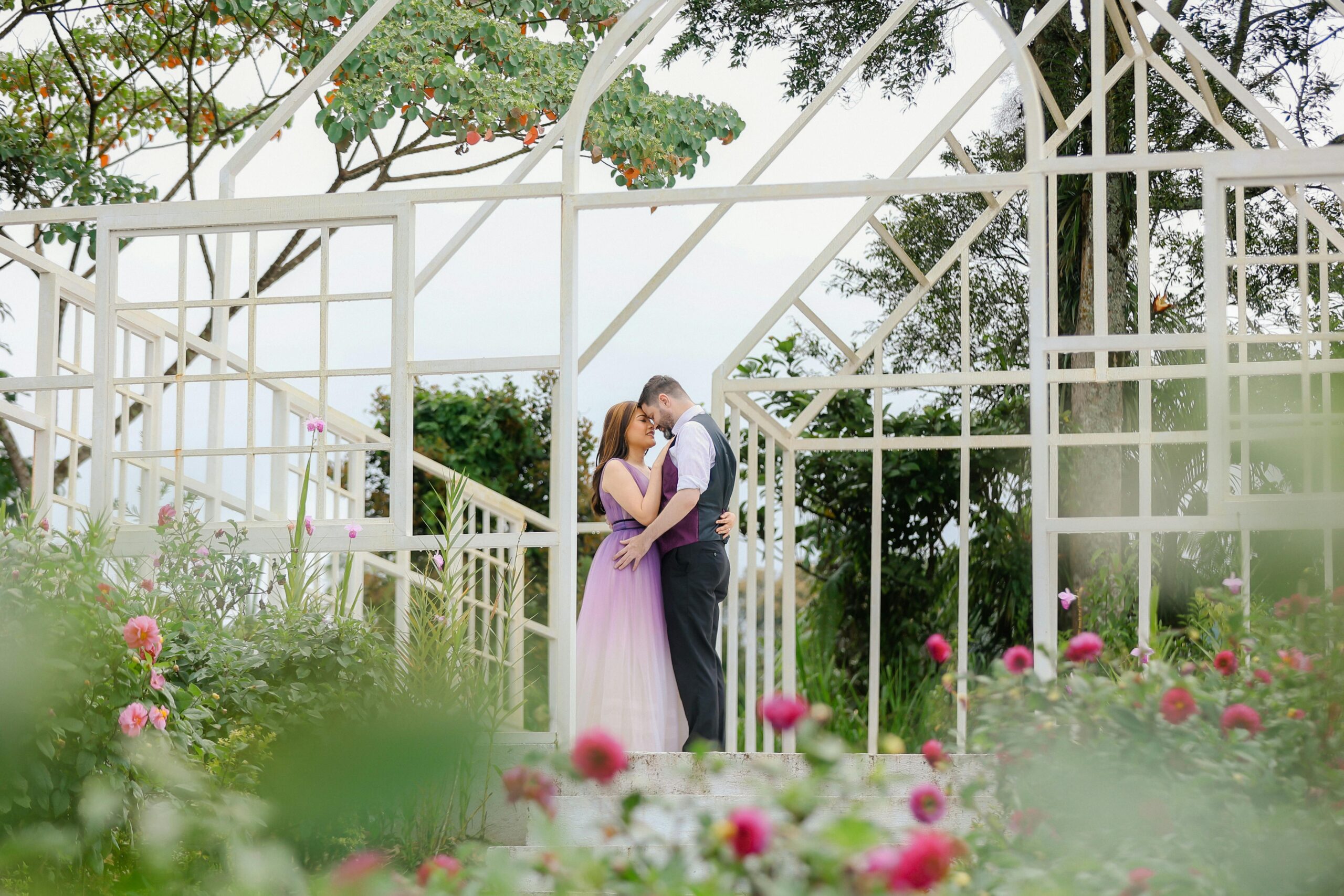 Couple embracing in a garden during an engagement photo shoot in Davao City.